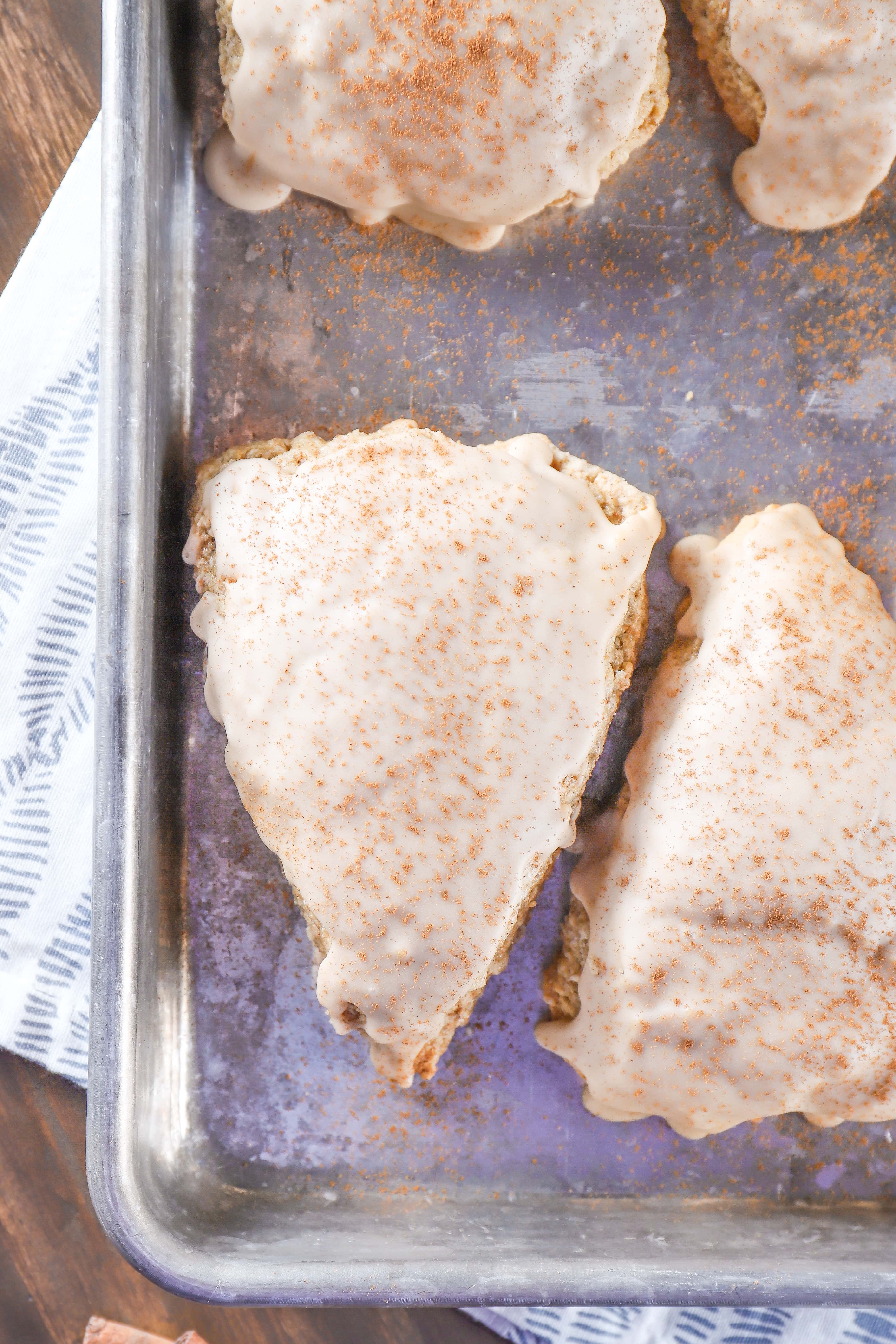 Glazed Maple Chai Scones on a baking sheet. Recipe from A Kitchen Addiction